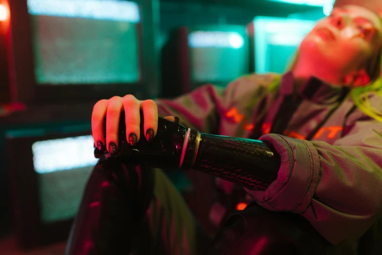 a close up of a person holding a remote control, cyberpunk art, inspired by Elsa Bleda, retrofuturism, wearing cyberpunk leather jacket, prosthetic arm, neon noir, beeple and mike winkelmann