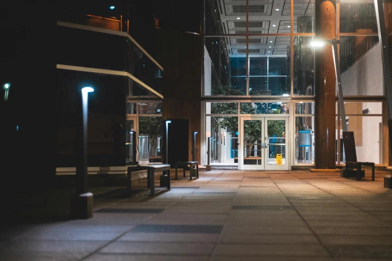 the inside of a building lit up at night, by Ryan Pancoast, under street lamp, high-quality photo, tall entry, peaceful environment