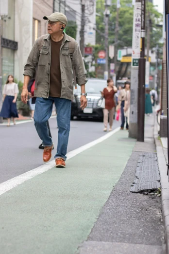 a man is walking down a city street, by Tadashige Ono, trending on unsplash, shin hanga, green and brown clothes, ad image, takata yamamoto style, 🚿🗝📝