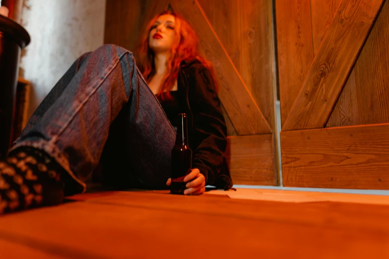 a woman with red hair sitting on the floor, inspired by Nan Goldin, pexels, renaissance, holding beer bottles, leaning on door, sky high level of alcoholism, a lonely woman