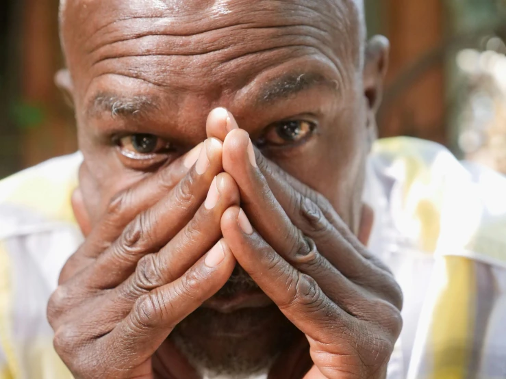 a man covers his face with his hands, pexels contest winner, samuel l jackson, wide nostrils, wrinkles, praying