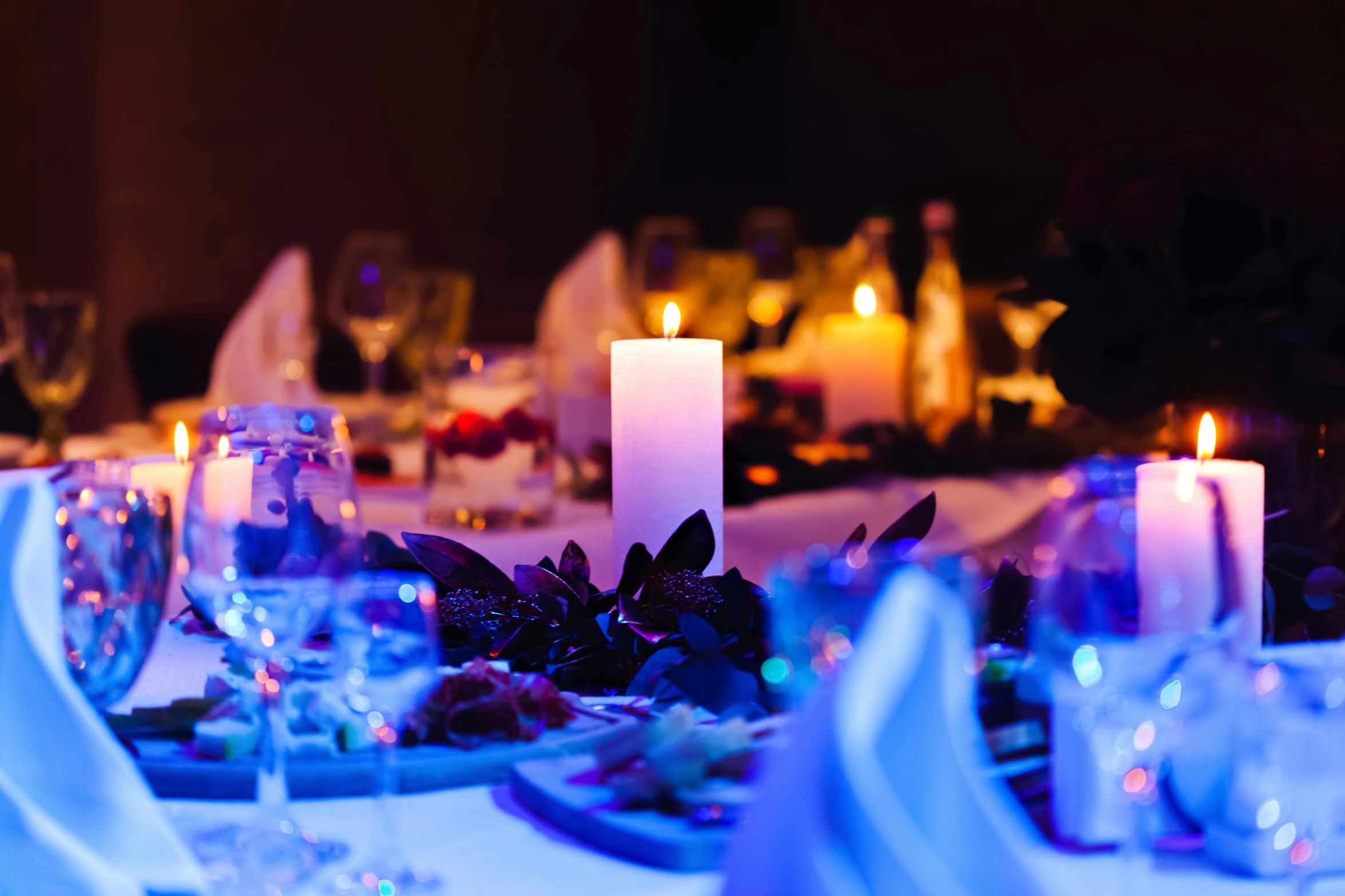 a close up of a table setting with candles, by Adam Marczyński, pexels contest winner, blue and purple lighting, white table, lights inside, fan favorite