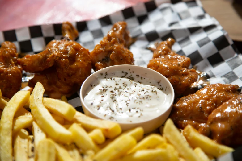 a close up of a plate of food with fries, feathered wings, braavos, thumbnail, fan favorite