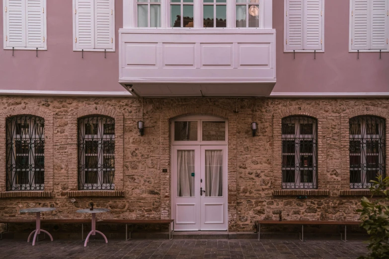 a couple of benches sitting in front of a building, pexels contest winner, art nouveau, pink door, greek ameera al taweel, apartment, light tan