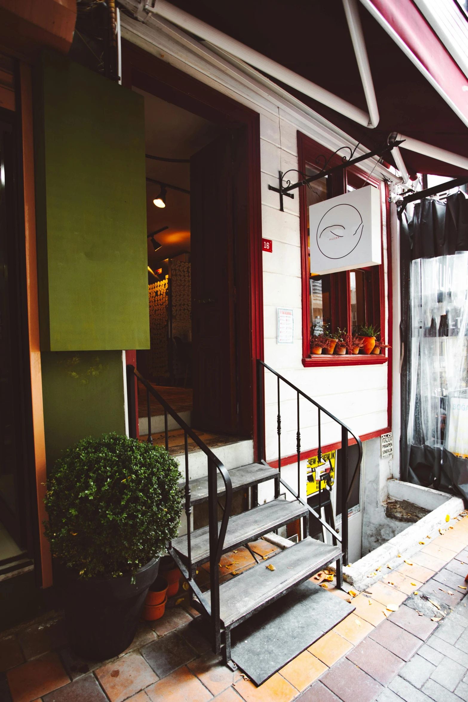 a green and white building with a red awning, a portrait, unsplash, renaissance, japanese akihabara cafe, small path up to door, parlor, autumnal