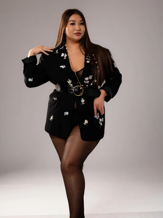 a woman in tights posing for a picture, floral bling, wearing a black blazer, curvy model, sexy :8