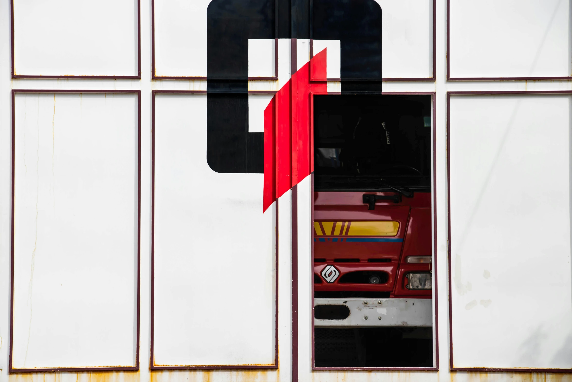 a red fire truck parked in front of a building, a picture, unsplash, de stijl, abstract detail, square, symbol, seen through a window