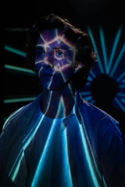 a man that is standing in the dark, a hologram, by Jacob Toorenvliet, portrait of timothee chalamet, made of lasers, promo photo, shpongle
