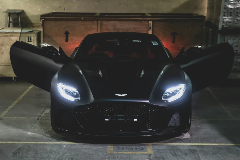 a black sports car parked in a garage, by Austin English, pexels contest winner, aston martin, custom headlights, avatar image, full body shot 4k