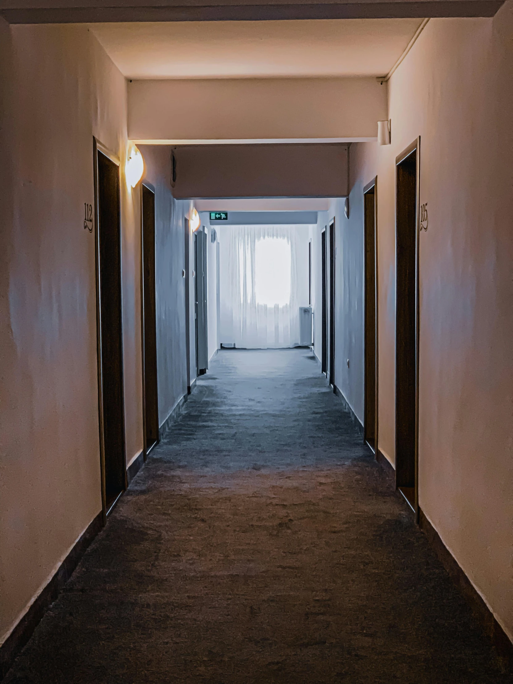 a long hallway with a light at the end of it, a photo, thumbnail, hotel room, non-binary, background image