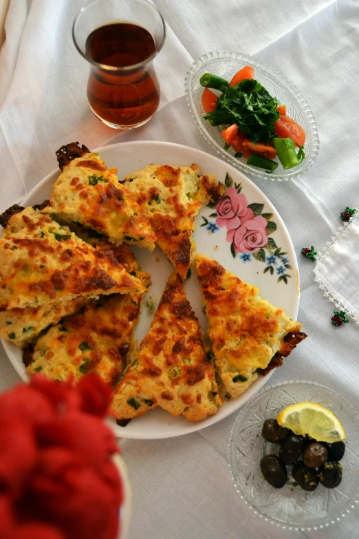 a close up of a plate of food on a table, a picture, inspired by Géza Dósa, reddit, arabesque, crust, toast, cheesy, mixture turkish and russian