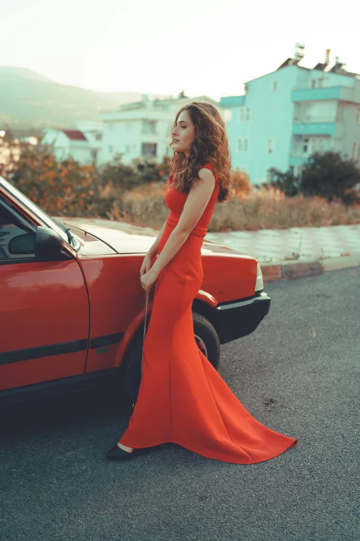 a woman in a red dress standing next to a red car, inspired by Elsa Bleda, pexels contest winner, renaissance, square, long dress female, orange tones, gorgeous elegant attractive