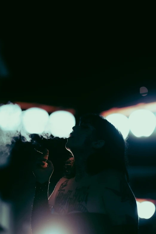 a couple standing next to each other in the dark, inspired by Elsa Bleda, pexels contest winner, outside alone smoking weed, in an arena pit, lo fi, shot in the sky
