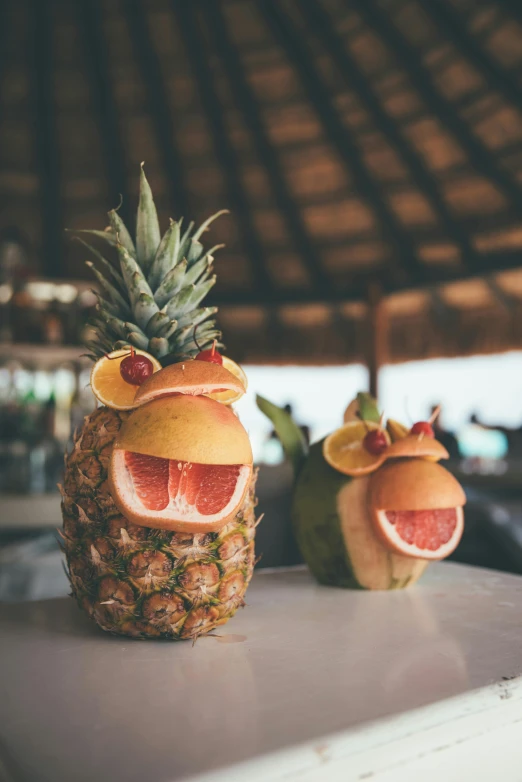 a couple of fruit sitting on top of a counter, inspired by Arcimboldo, pexels contest winner, beach bar, cute coronavirus creatures, garnish, resort