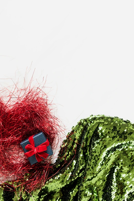 a green dress with a red bow on top of it, red scarf, zoomed in, presents, metallic red