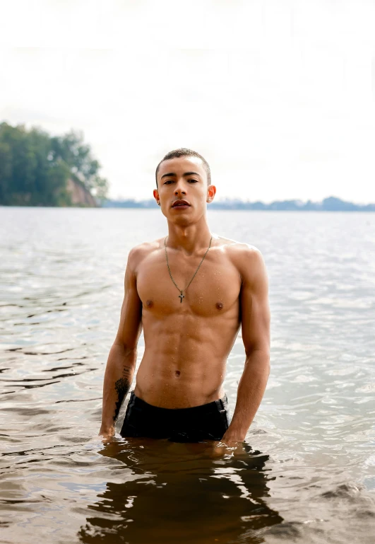 a shirtless man standing in a body of water, an epic non - binary model, justin sun, on a lake, buzz cut