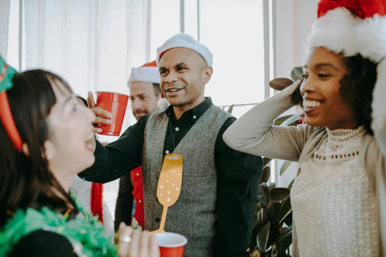 a group of people standing next to each other at a party, pexels contest winner, wearing a santa hat, people at work, avatar image, cups and balls