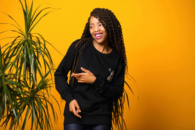 a woman standing in front of a potted plant, an album cover, pexels contest winner, wearing a black sweater, super cute funky black girl, portrait shot 8 k, with index finger