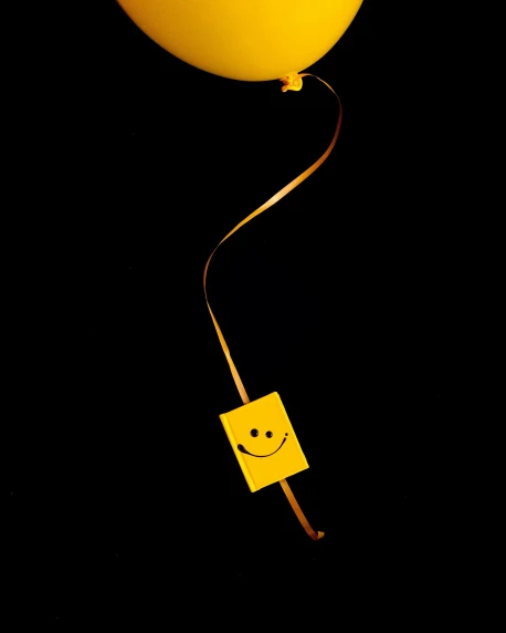 a yellow balloon with a smiley face on it, by Adam Chmielowski, conceptual art, cigarette dangling, diode, amoled, ribbon