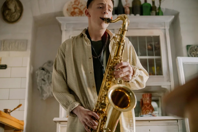 a man playing a saxophone in a kitchen, trending on pexels, hyperrealism, jamie campbell bower, albino, brass plated, large tall