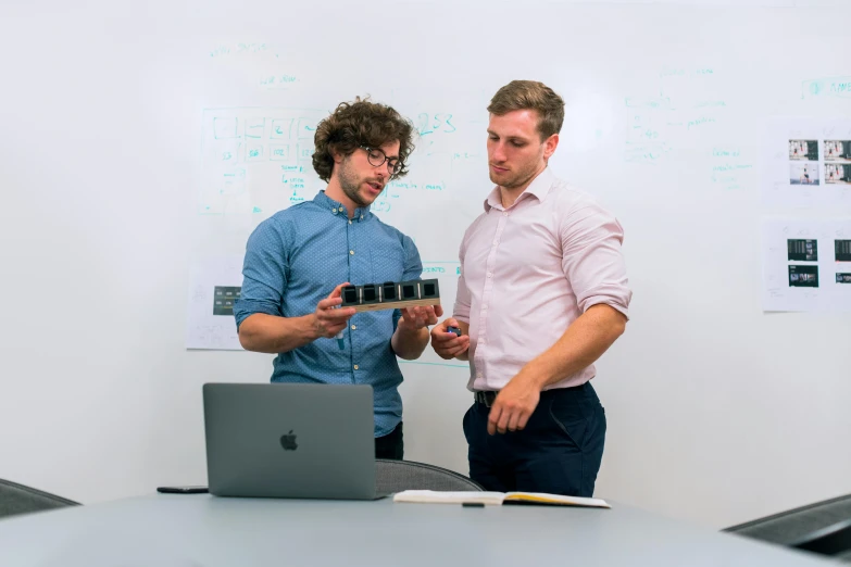 two men standing next to each other in front of a laptop, a computer rendering, pexels contest winner, product design shot, lachlan bailey, engineering, rectangle