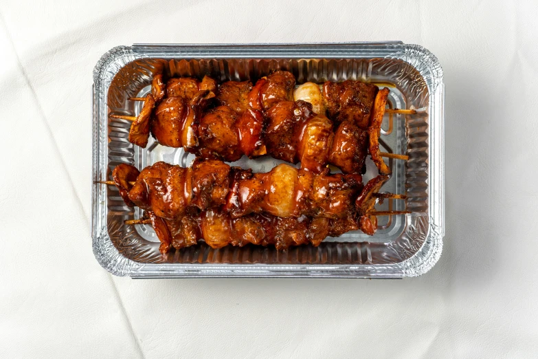 a close up of a tray of food on a table, product image, skewer, front facing shot, caramel