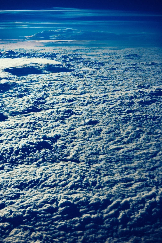 a view of the sky and clouds from an airplane, an album cover, nasa image