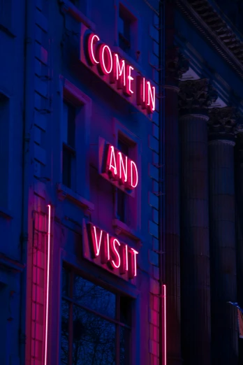 a neon sign that says come in and visit, by David Donaldson, trending on pexels, visual art, magenta and blue, late evening, photos