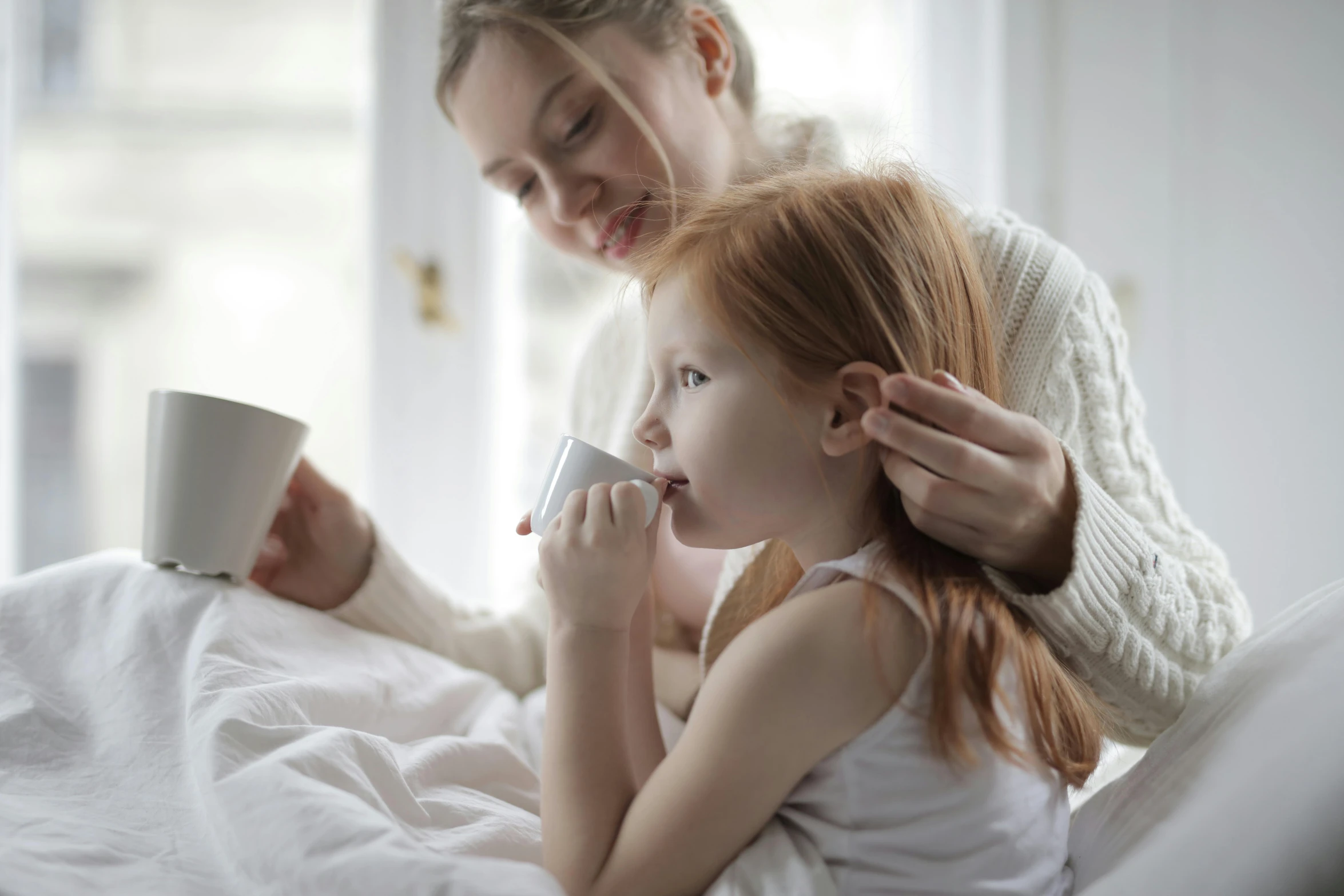 a woman is brushing a little girl's hair, pexels contest winner, drinking cough syrup, manuka, ( redhead, someone in home sits in bed