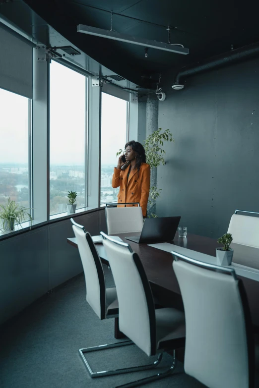 a woman sitting at a table talking on a cell phone, top floor boss shit, 2019 trending photo, overcast mood, standing straight