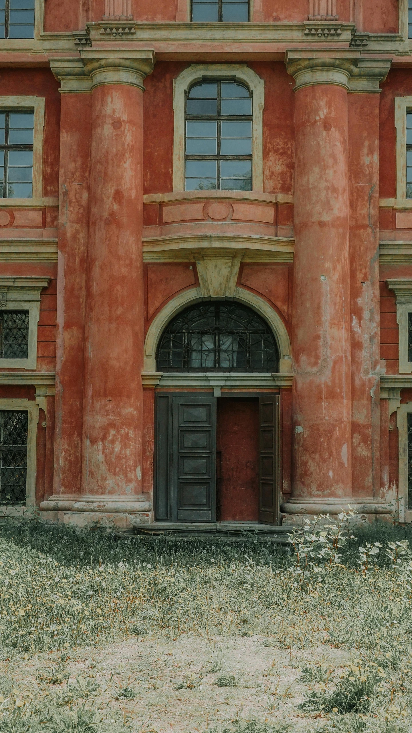 a red building with a clock on top of it, an album cover, inspired by Matthias Jung, pexels contest winner, renaissance, abandoned polish mansion, doorway, faded chipped paint, russian neoclassicism