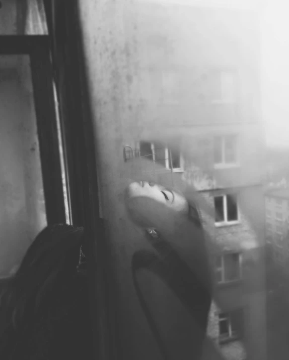 a black and white photo of a person looking out a window, a black and white photo, by Emma Andijewska, tumblr, surrealism, ecstasy and cry from far, selfie, julia gorokhova, alternate album cover