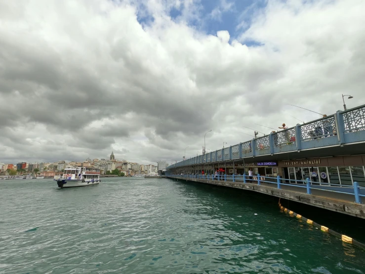 a bridge over a body of water under a cloudy sky, hurufiyya, istanbul, fish seafood markets, 2022 photograph, gigapixel photo