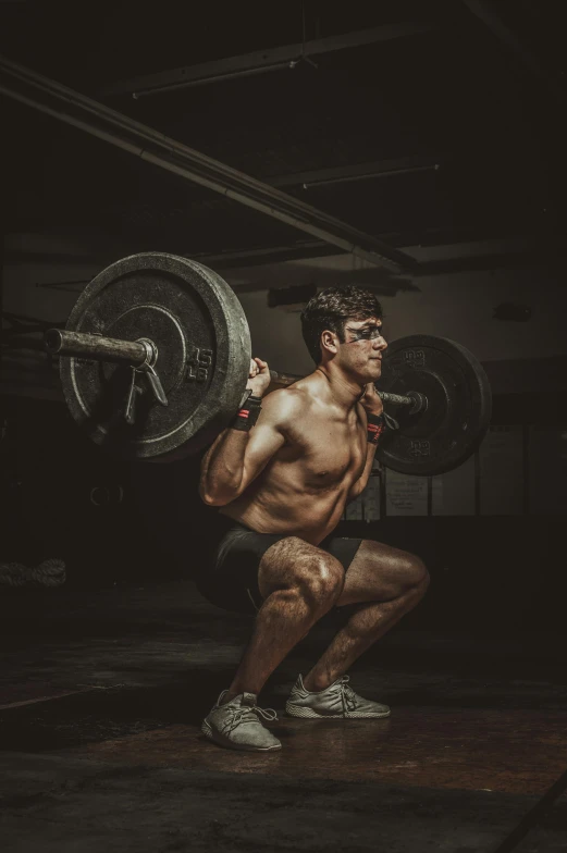 a man squatting with a barbell in a gym, by Adam Marczyński, pexels contest winner, renaissance, dirty and sweaty, plain background, strong artificial intelligence, instagram picture