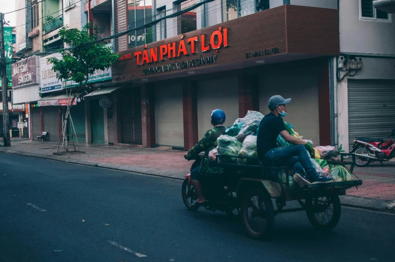 a group of people riding on the back of a motorcycle down a street, by Daniel Lieske, unsplash contest winner, temporary art, shopping carts full of groceries, dang my linh, avatar image