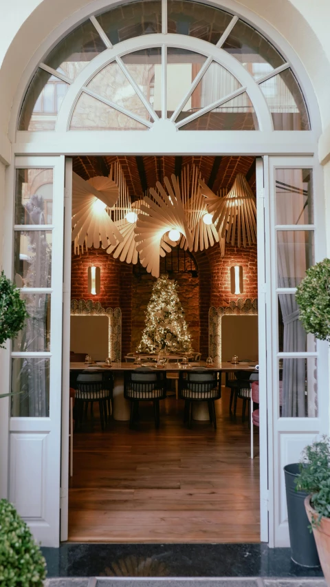 a doorway with a christmas tree inside of it, a digital rendering, pexels contest winner, light and space, restaurant, nate berkus, natural lighting, spanish
