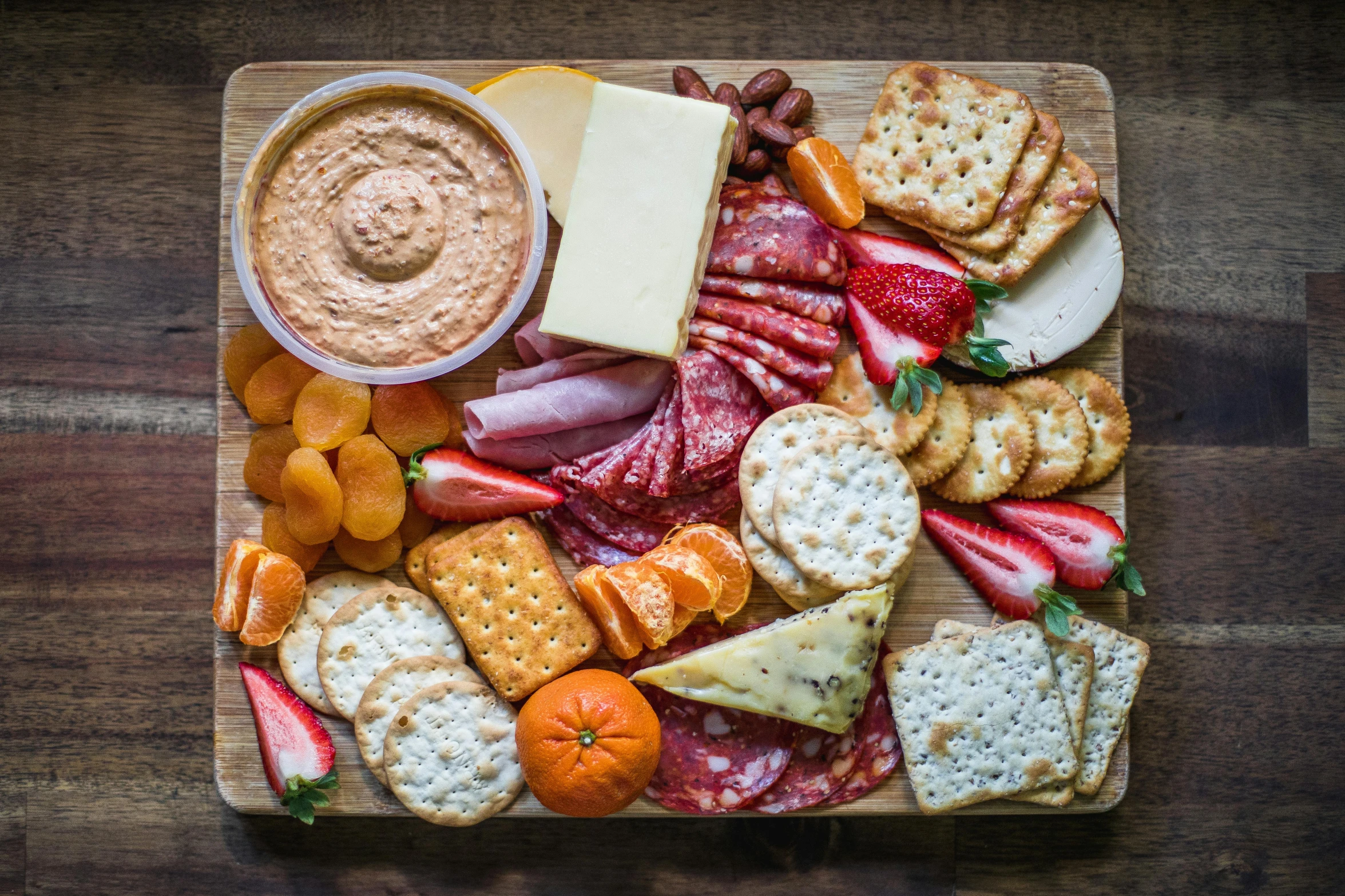 a platter of fruit, cheese, crackers and crackers, a portrait, pexels contest winner, meaty, 🦩🪐🐞👩🏻🦳, red and orange color scheme, guide