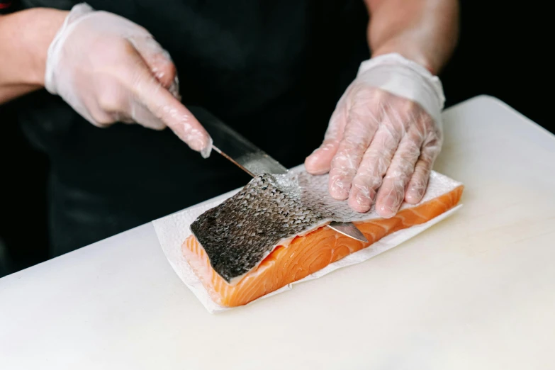 a person cutting a piece of salmon on a cutting board, an album cover, trending on pexels, fish skin, bao pham, thumbnail, plating