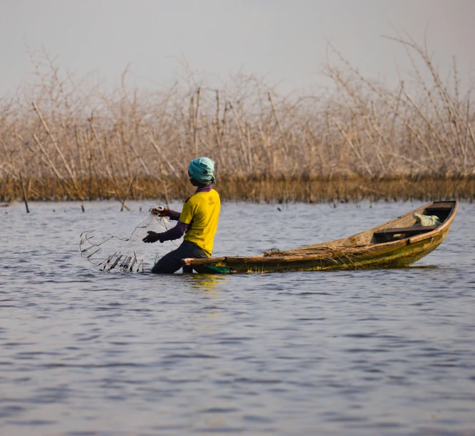 a person in a boat on a body of water, by Jan Tengnagel, pexels contest winner, hurufiyya, chad, swamps, working hard, 🦩🪐🐞👩🏻🦳