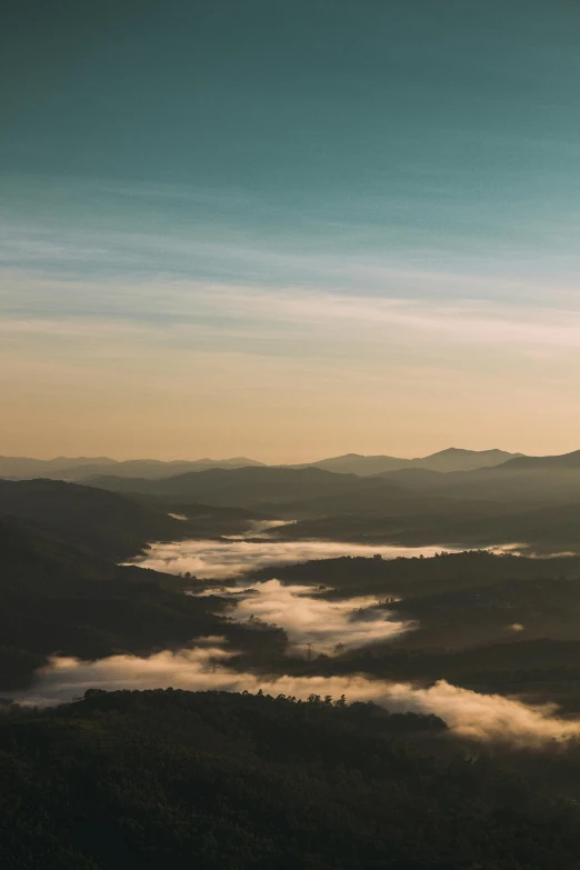 a couple of people standing on top of a mountain, by Ben Thompson, unsplash contest winner, hudson river school, above low layered clouds, 4 k cinematic panoramic view, distant town in valley and hills, during dawn