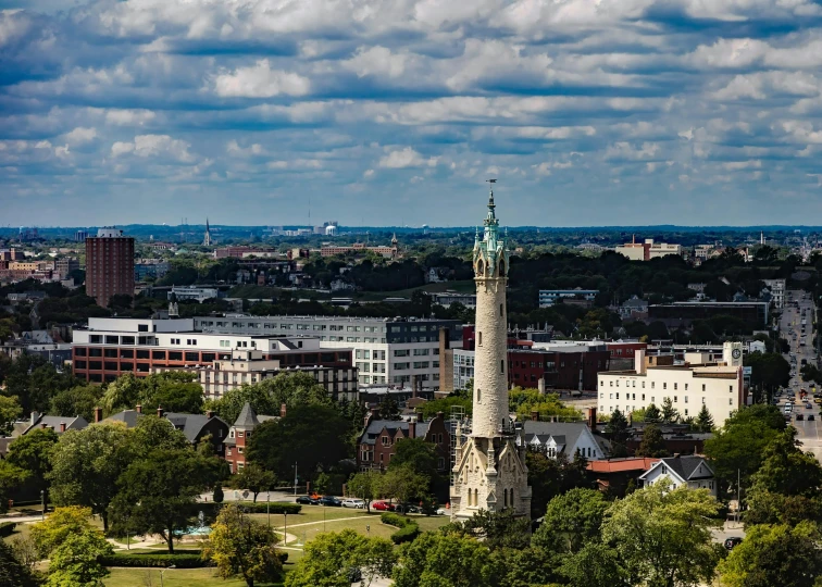 a clock tower sitting in the middle of a lush green park, by Washington Allston, unsplash contest winner, art nouveau, super wide view of a cityscape, michigan, chimneys, hannover