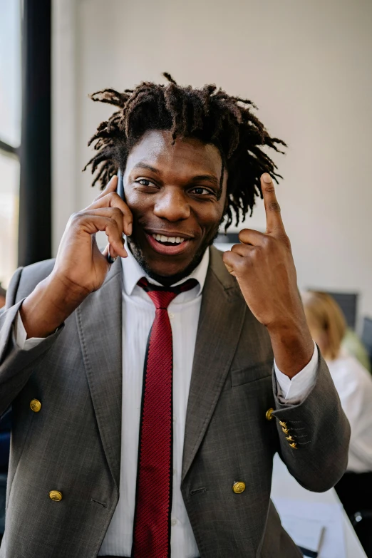 a man in a suit talking on a cell phone, inspired by Charles Martin, trending on pexels, renaissance, dreads, proud looking, schools, big horns