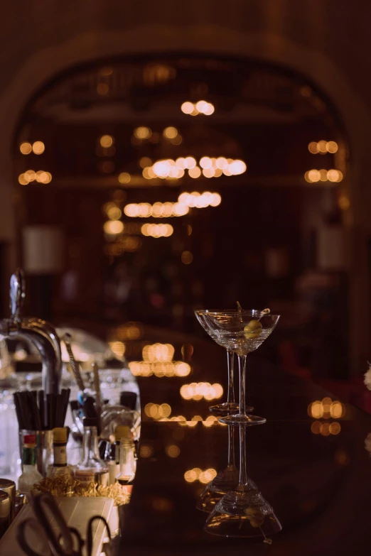 a group of wine glasses sitting on top of a table, in opulent library, modern crystal martini glass, chinatown bar, cinestill 800t 50mm eastmancolor