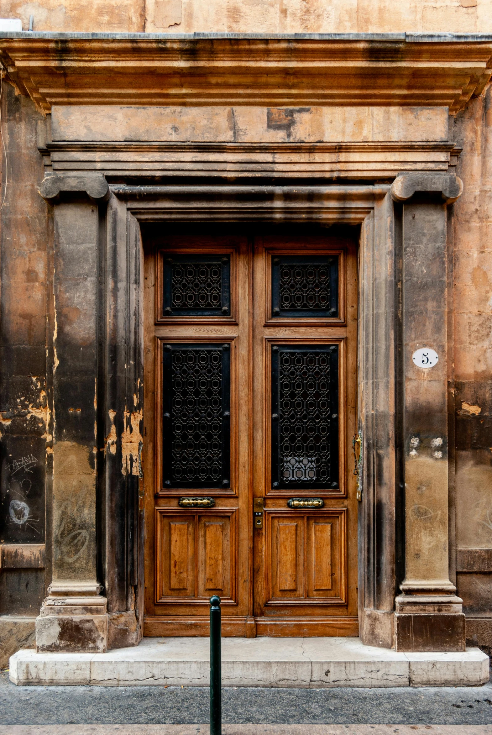 a red fire hydrant sitting in front of a wooden door, by Sven Erixson, renaissance, neoclassical architecture, black and brown, glasgow, rustic