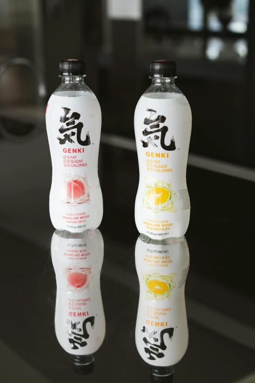 a couple of bottles sitting on top of a table, inspired by Kanō Tan'yū, yogurt, yinyang shaped, lemonade, medium close shot