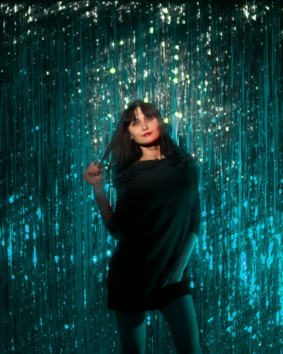 a woman standing in front of a rain curtain, inspired by Elsa Bleda, holography, teal lights, portrait of eva green, zoey deschannel, 3 meters