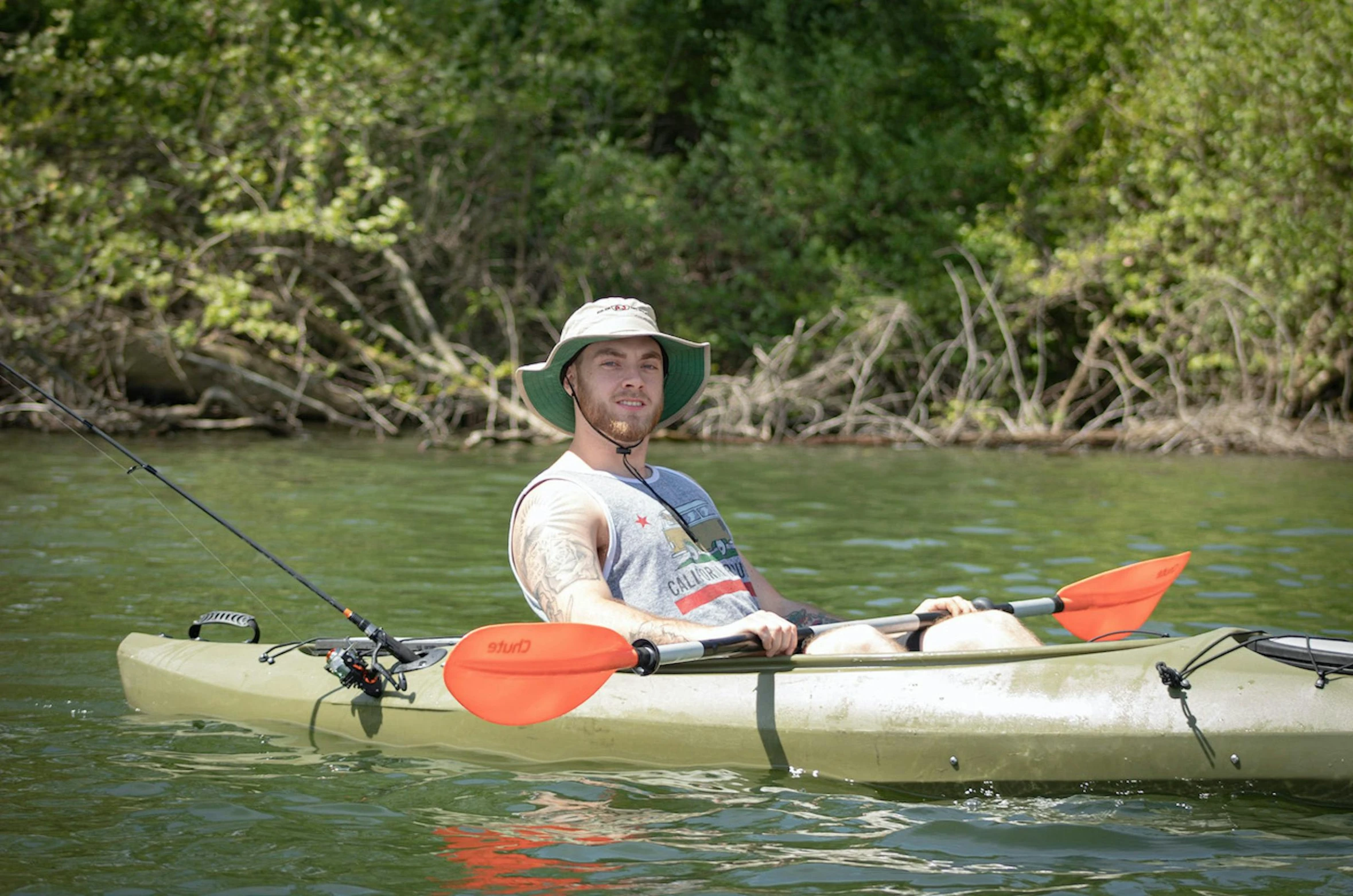 a man sitting in a kayak in the water, zachary corzine, avatar image