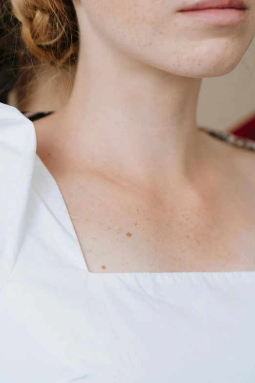 a woman in a white dress posing for a picture, a tattoo, inspired by Elsa Bleda, unsplash, renaissance, neck zoomed in, white with chocolate brown spots, in elegant decollete, detailed product image