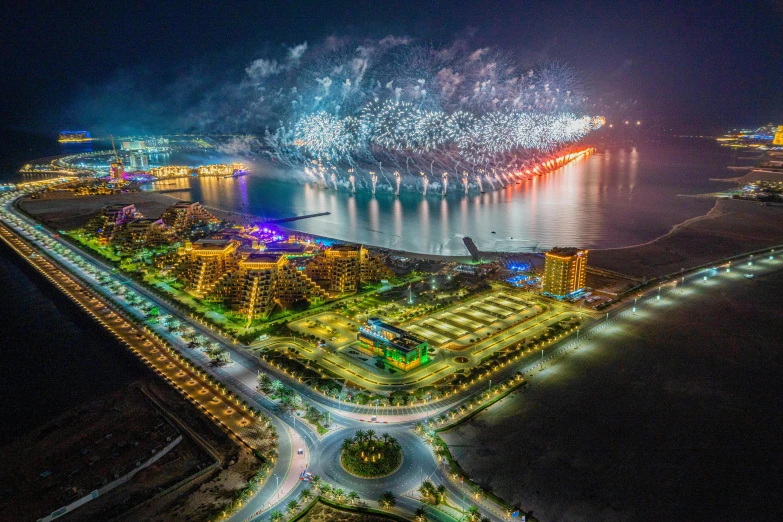 fireworks in the sky over a large body of water, pexels contest winner, arab ameera al taweel, aerial photography, construction, national geographic photograph