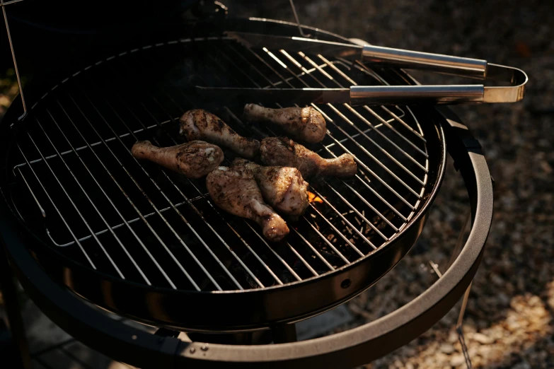 a close up of a grill with chicken on it, by Paul Bird, 3 - piece, cinematic image, high angle shot, black